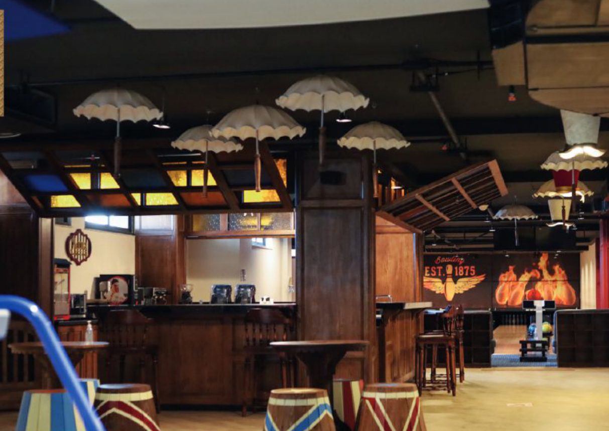 Agora bowling and gaming center interior with hanging umbrella light fixtures and bar seating