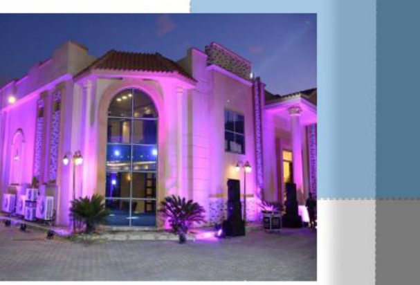 purple-lit nighttime exterior of wedding hall
