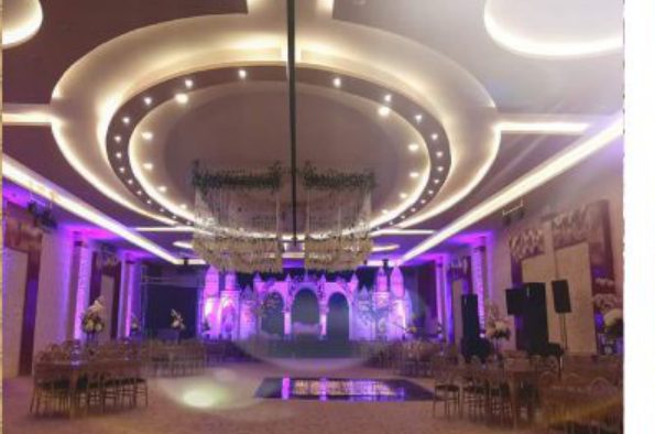 circular coffered ceiling under purple lighting