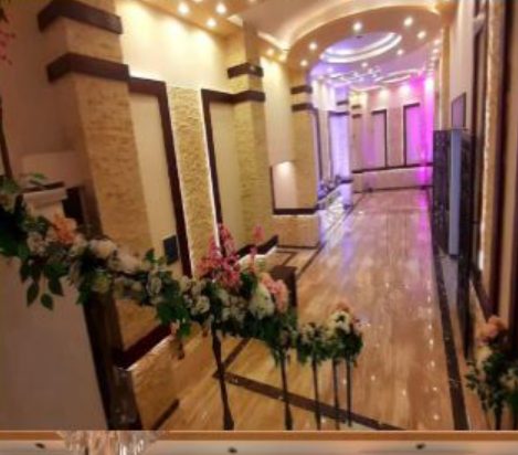 chandelier-lit columned corridor