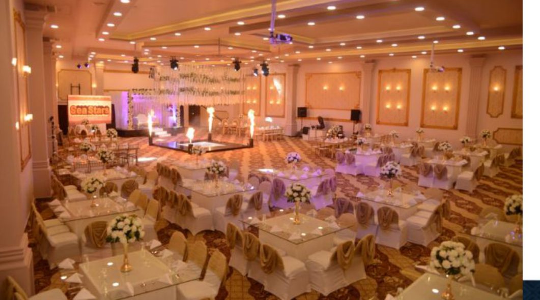 banquet ballroom set for event with uplighting