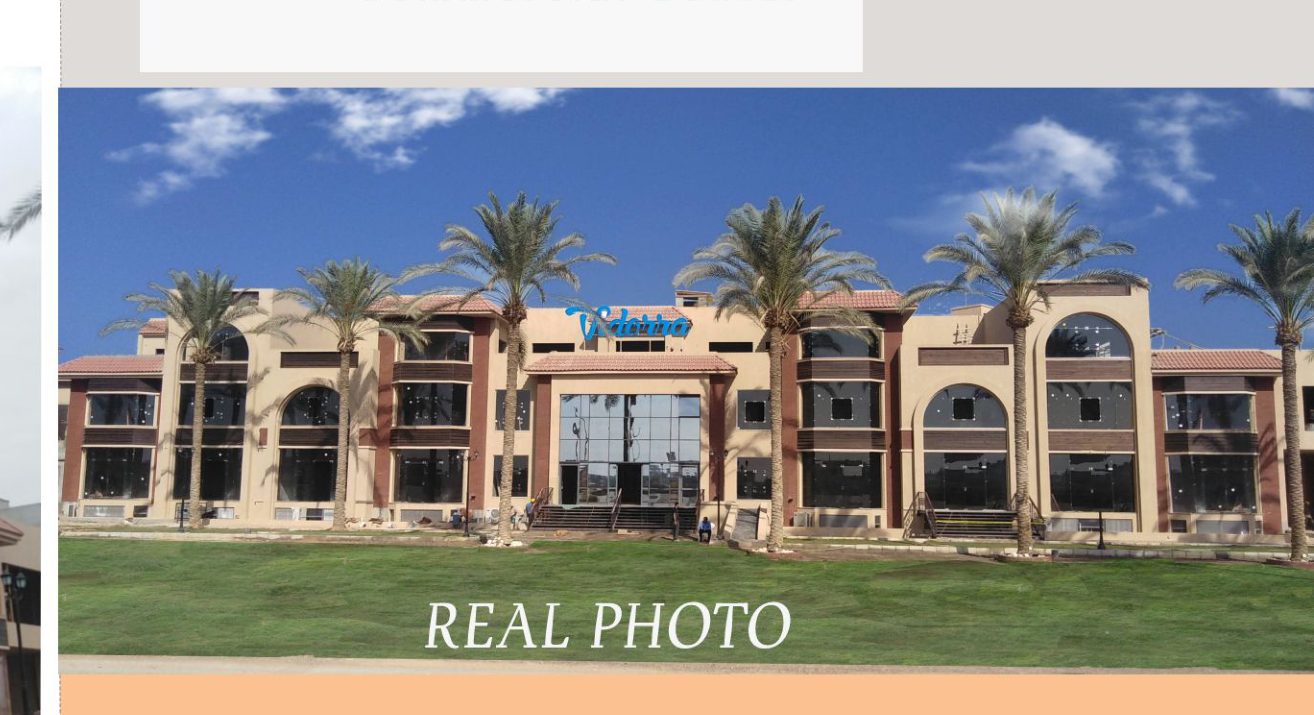 Vidorra completed building — daytime real photo of facade with palm trees