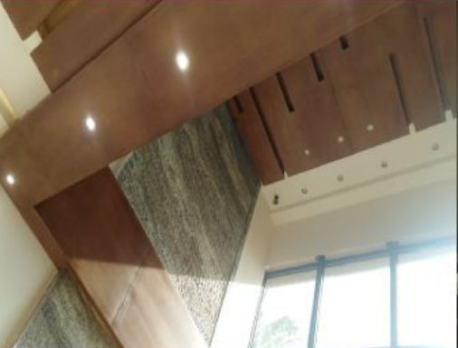 timber-clad ceiling detail with stone wall
